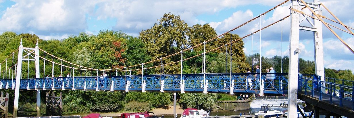 Blue bridge with a river. Parked ships