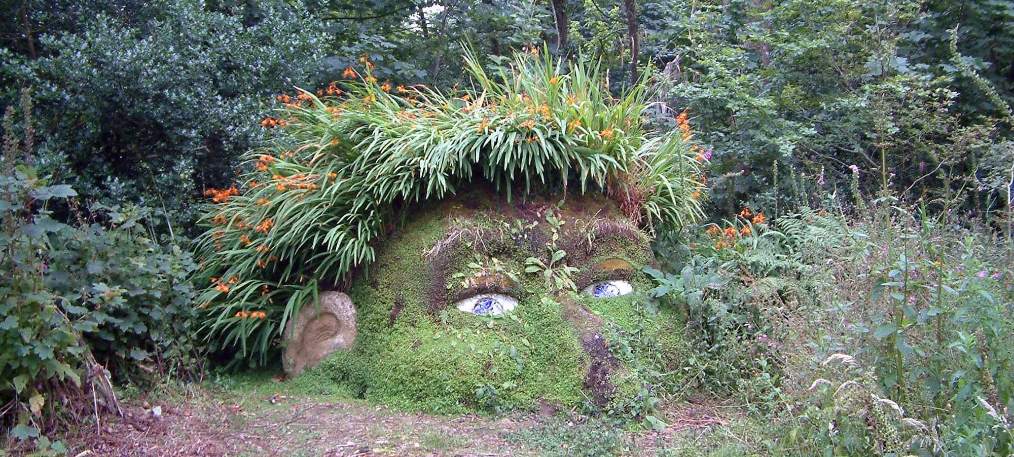 Looks like a face half in the ground. Made of stone, sand and grass