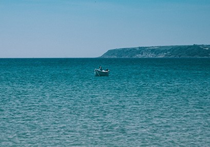 Clear ocean water and a little boat