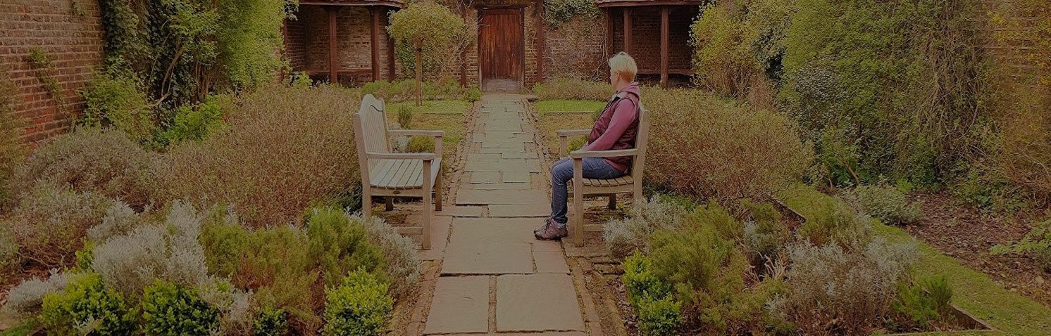 Woman sitting on a bench in the garden