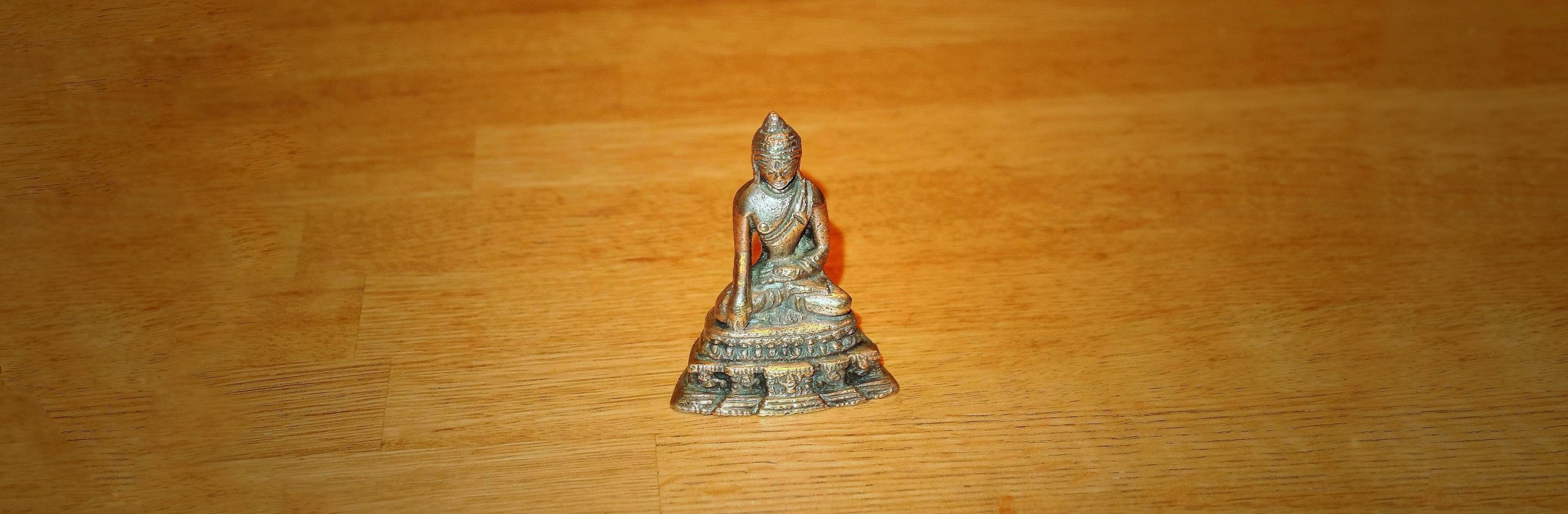 Little brass meditating Buddha statue